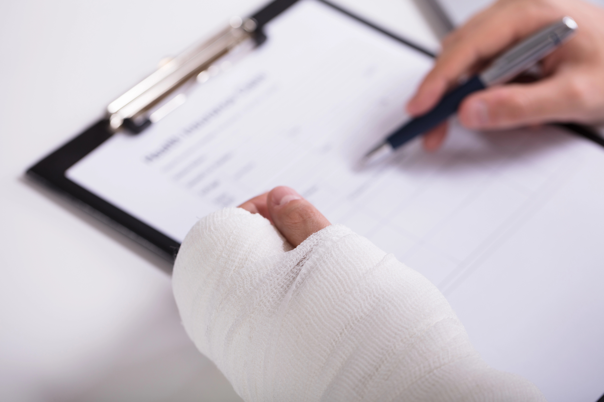 Injured person filling out paperwork