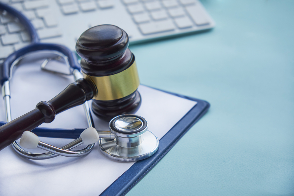Common Office-Related Work Injuries - Gavel and stethoscope. medical jurisprudence. legal definition of medical malpractice. attorney. common errors doctors, nurses and hospitals make.