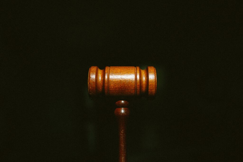 Workers' Compensation Facts - A wooden gavel centered on a dark background with grain.