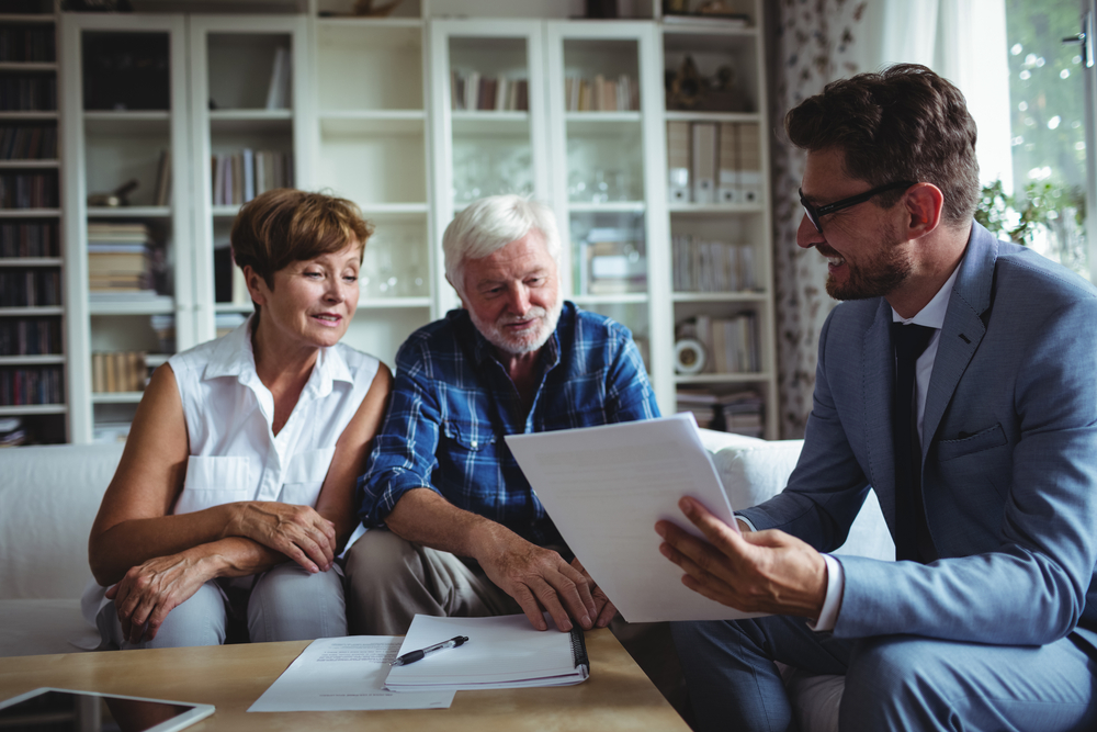 Older couple consulting with a New York Workers' Compensation lawyer over their options